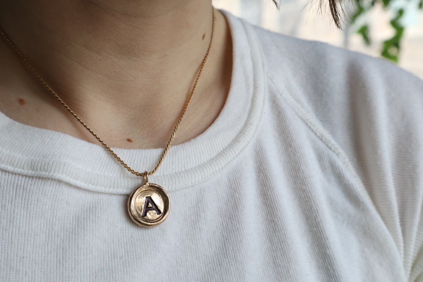 initial pendant in bronze