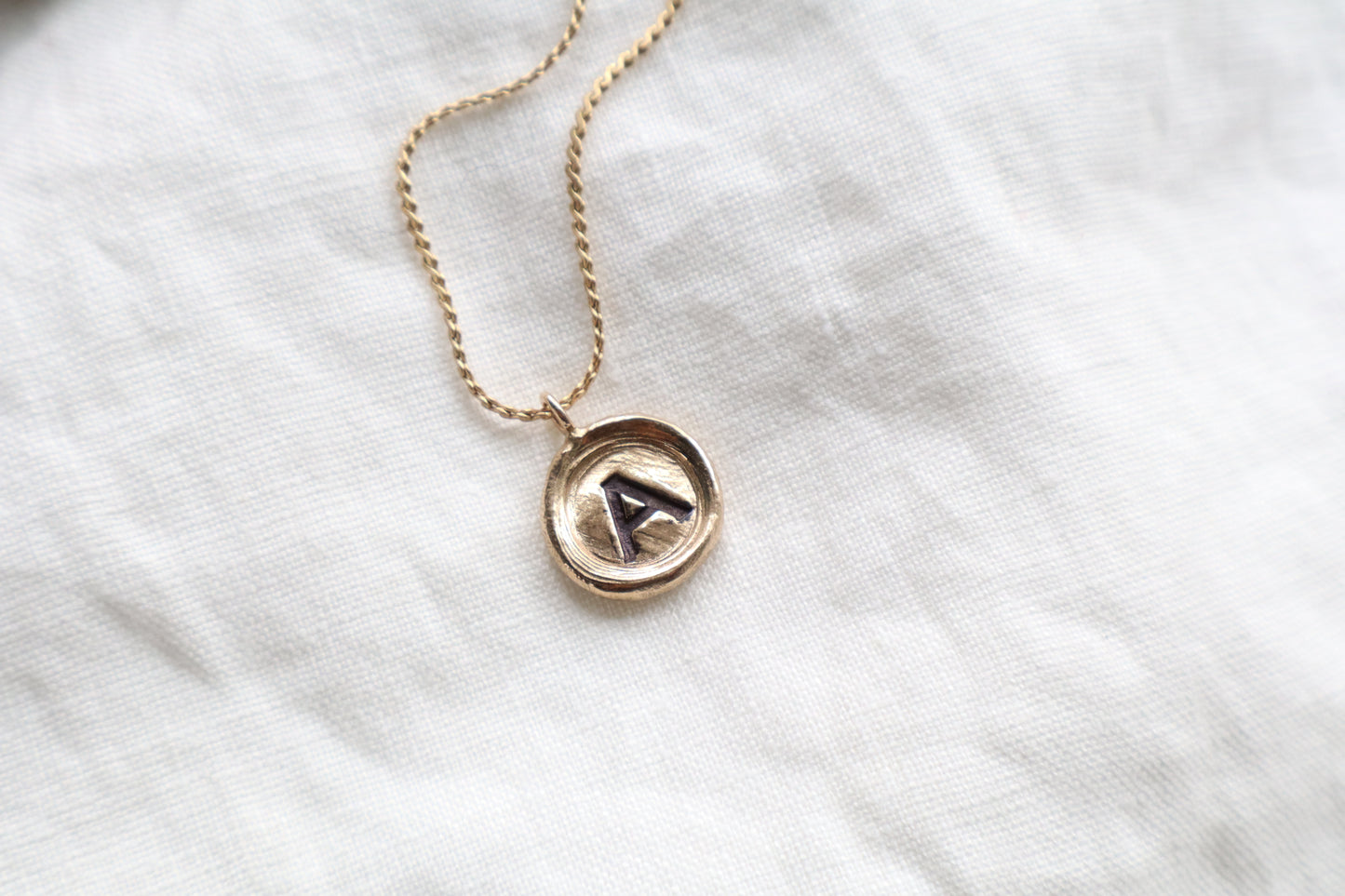 initial pendant in bronze